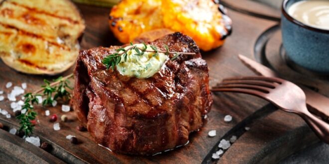 Grilled,Beef,Tenderloin,Steak,On,A,Wooden,Board,With,Butter